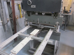 An arbor press  set up to make the a small bend required in the fabrication of a Cessna lower aileron skin