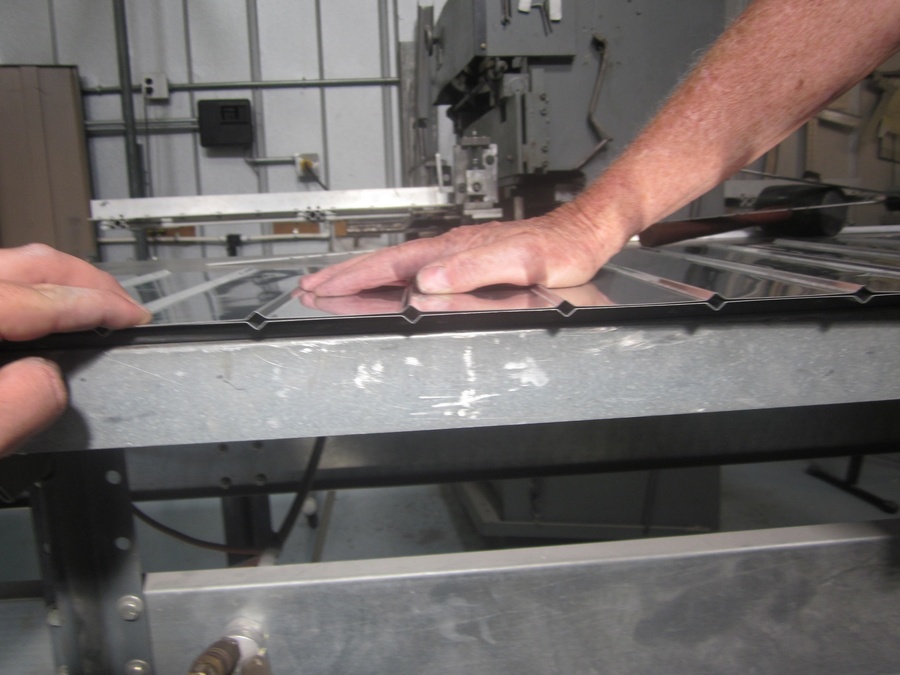 An arbor press set up to make the a small bend required in the 