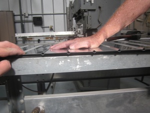 An arbor press  set up to make the a small bend required in the fabrication of a Cessna lower aileron skin