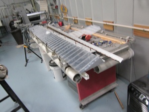 An arbor press  set up to make the a small bend required in the fabrication of a Cessna lower aileron skin