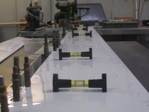 An arbor press  set up to make the a small bend required in the fabrication of a Cessna lower aileron skin