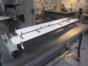 An arbor press  set up to make the a small bend required in the fabrication of a Cessna lower aileron skin